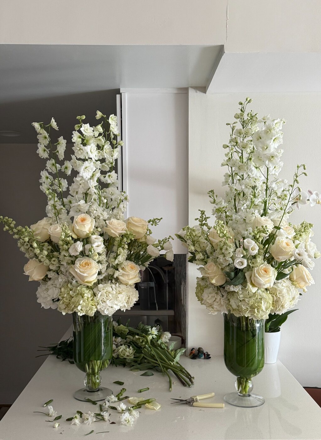 A pair of tall white floral arrangements