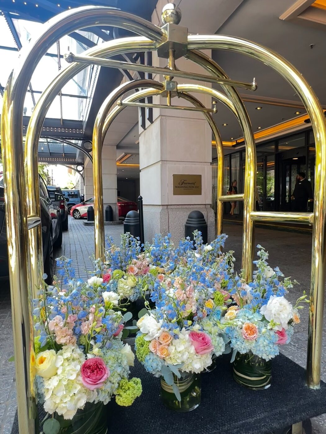 Blue and pink flowers on a gold cart