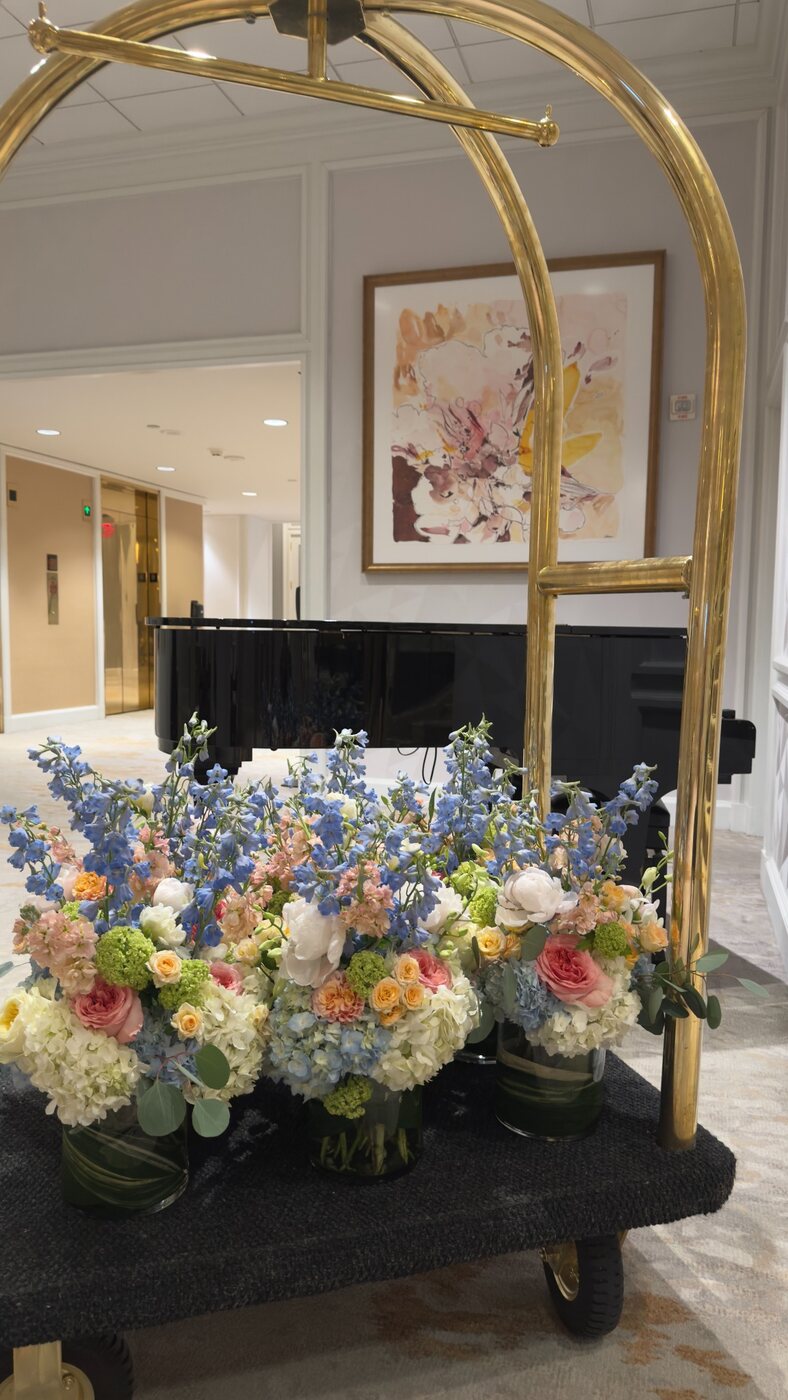 Colorful flowers arranged on a gold cart