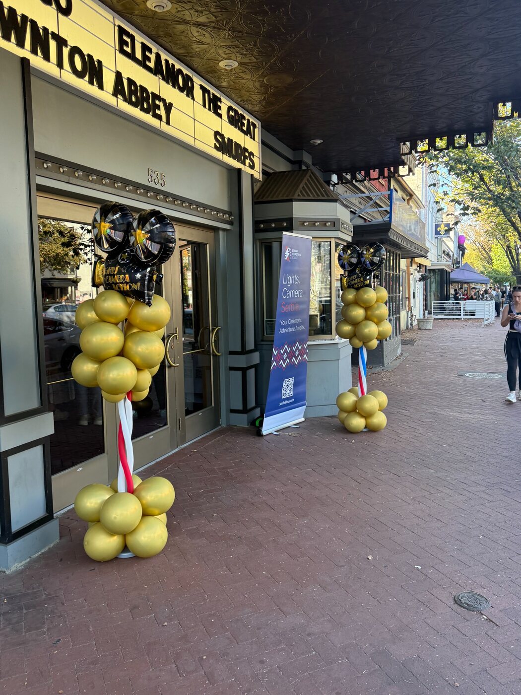 Gold balloon columns outside a venue